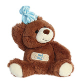 A brown bear plush toy from Aurora World with a blue hat and a “Get Well” tag.