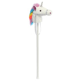 A white unicorn toy hobby horse plush toy from Giddy-Up Friends with a silver horn and rainbow mane.