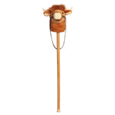 A Highland cow plush stick toy with a soft cow head and wooden stick from Aurora’s Giddy-Up Friends collection.
