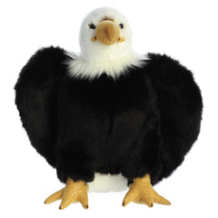 A brown and white eagle plush toy from Aurora with a yellow beak and realistic feather accents.
