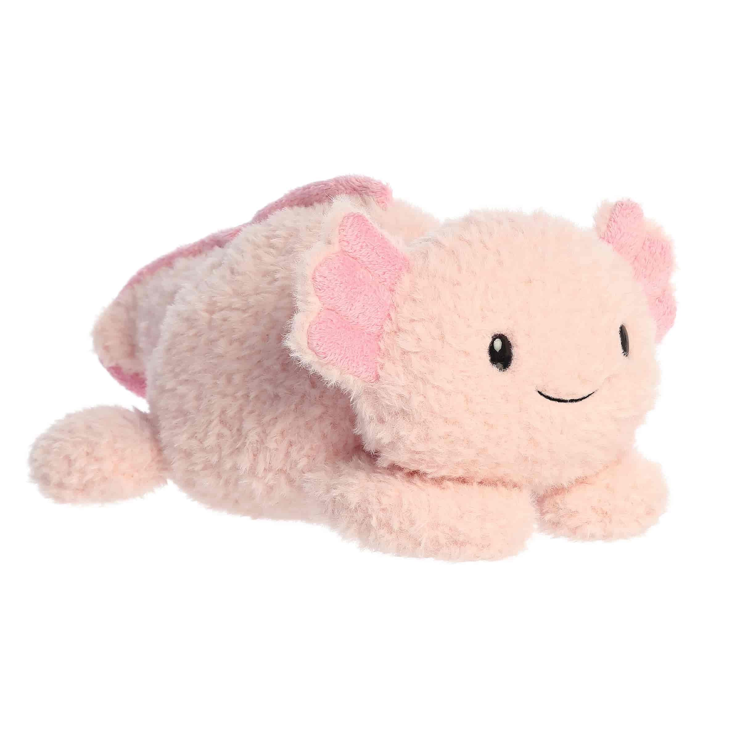 A soft pink plush axolotl with a rounded body and relaxed pose from Rumplers by Aurora plush.