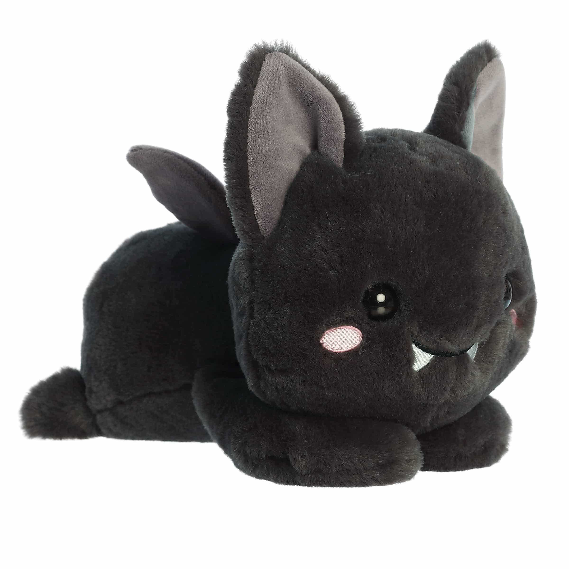 Plush bat with belly-down posture and sprawling arms, featuring gentle eyes and soft fur.