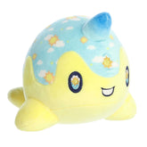 A yellow and blue Tasty Peach Nomwhal plush that is an expressive narwhal with big sparkling embroidered eyes