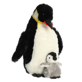 A black and white penguin plush toy from Aurora with yellow accents and a fuzzy gray baby chick.