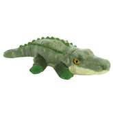 A green alligator plush from Mini Flopsie by Aurora with yellow eyes and a textured, scaly design