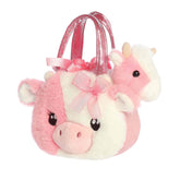 A pink-and-white cow plush inside a matching pink carrier with a bow from Fancy Pals by Aurora.