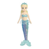 A blonde mermaid plush with a blue top and shimmering rainbow tail from Sea Sparkles by Aurora.