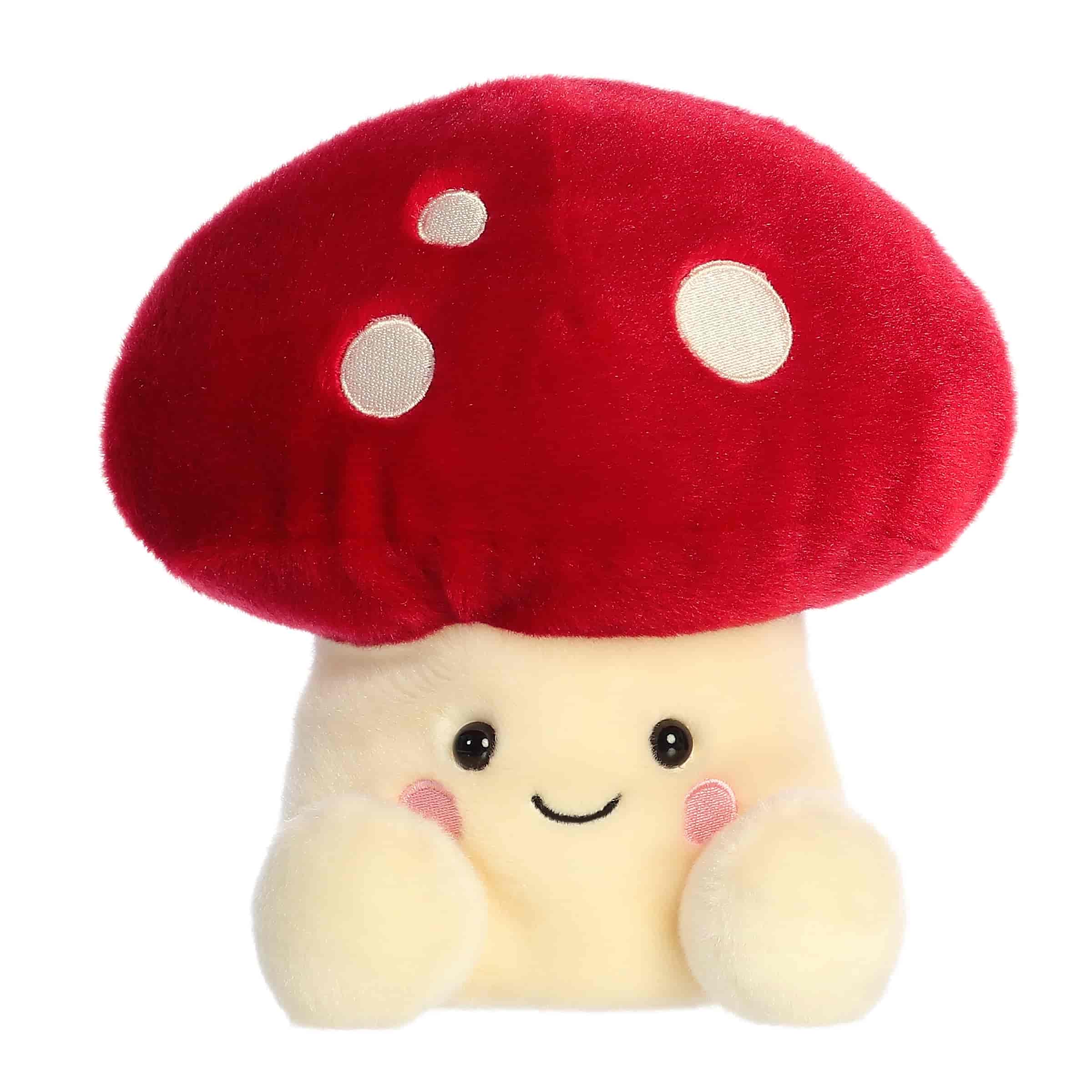 Larger toy of red Amanita mushroom plush in the Palm Pals collection, with a smiling face and white spots.