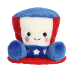 A small red, white, and blue hat plush with embroidered stars from Palm Pals by Aurora.
