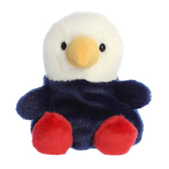 A small eagle plush with red, white, and blue accents from the Palm Pals collection by Aurora.