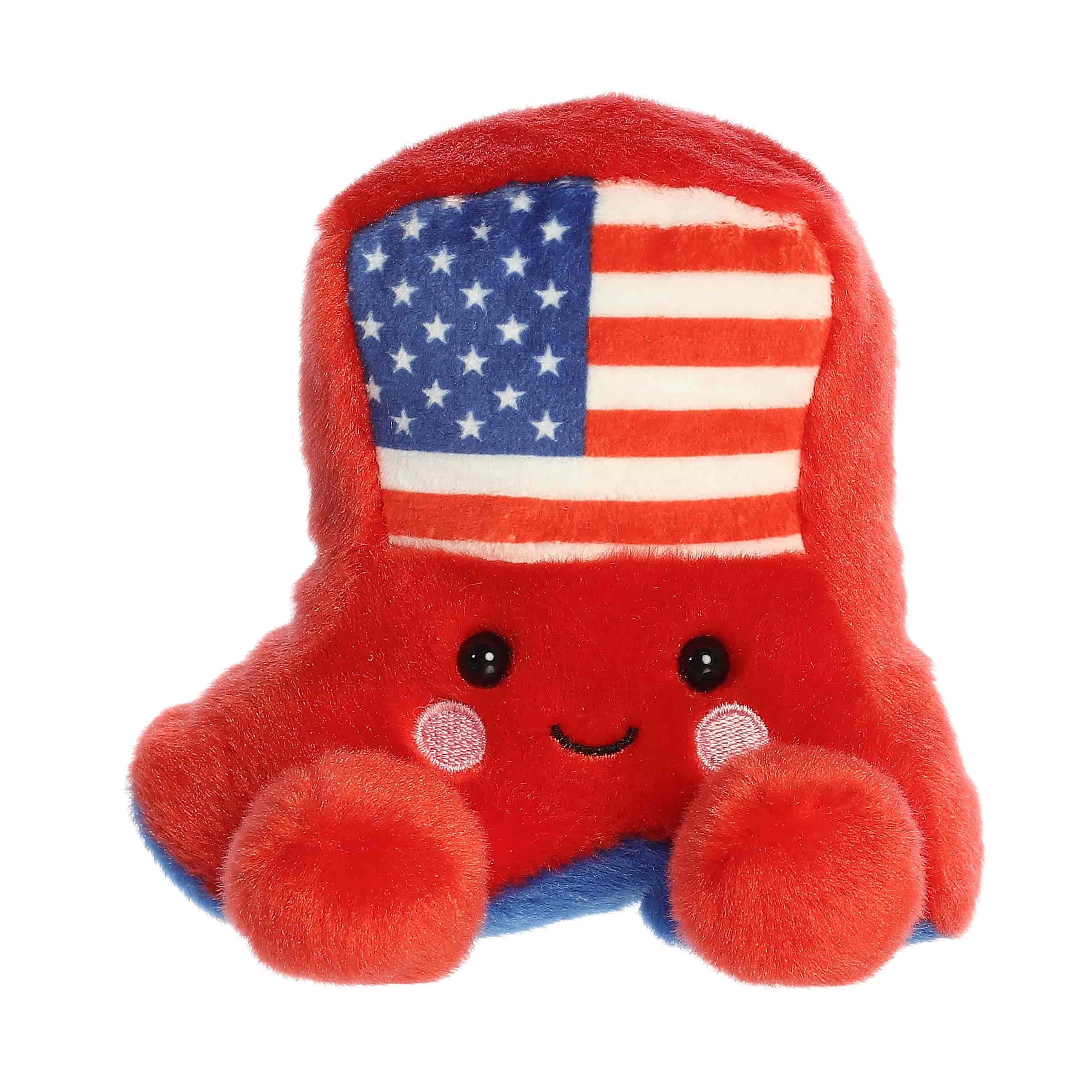 A small red cowboy boot plush with blue accents and a star-spangled flag design from Palm Pals by Aurora.