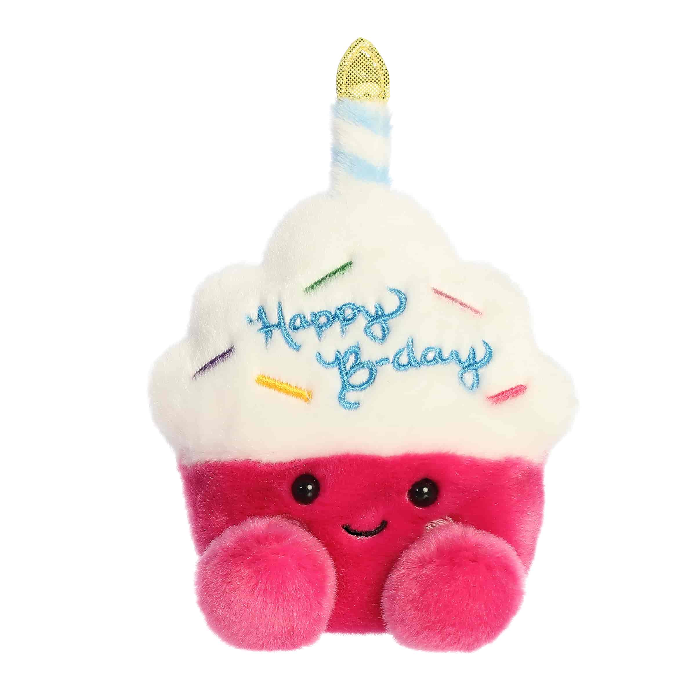 A small pink cupcake plush with white frosting and a shimmering candle from Palm Pals by Aurora.