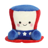 A large red, white, and blue hat plush with embroidered stars from the Party-Sized Palm Pals collection by Aurora.