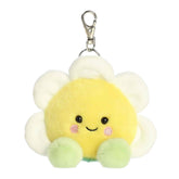 A small yellow daisy plush clip-on with white petals and green feet from Palm Pals by Aurora.