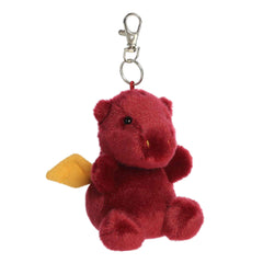 A small red dragon plush clip-on with golden wings and bright eyes from Palm Pals by Aurora.