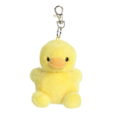 A small yellow duck plush clip-on with an orange beak and round body from Palm Pals by Aurora.