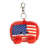 A small red, white, and blue duck plush clip-on with stars and stripes from Palm Pals by Aurora.