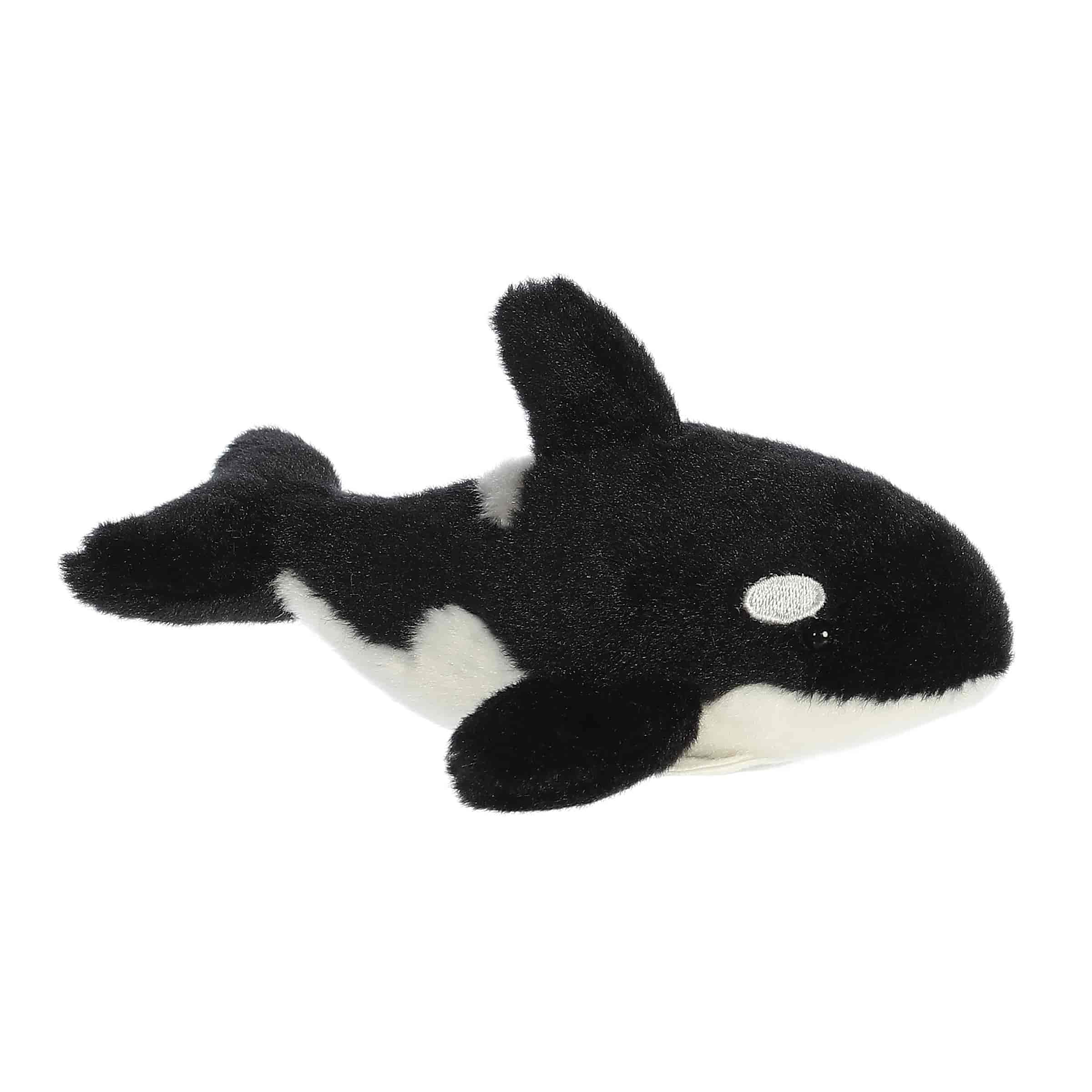 A black-and-white orca plush with fins and a magnetic base from Shoulderkins by Aurora.