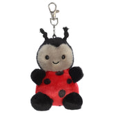 A ladybug plush clip-on from Aurora with a red body, black spots, and tiny antennae.