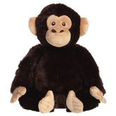 A chimpanzee plush toy from Aurora with dark fur, an expressive face, and a realistic pose.
