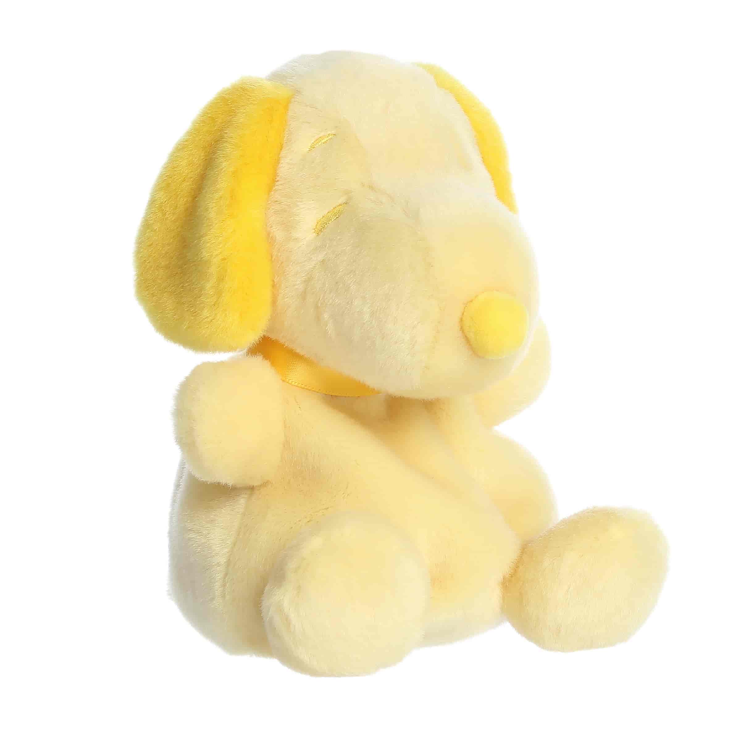 A yellow Snoopy plush beagle with soft rounded shape from Palm Pals Snoopy Color Collection