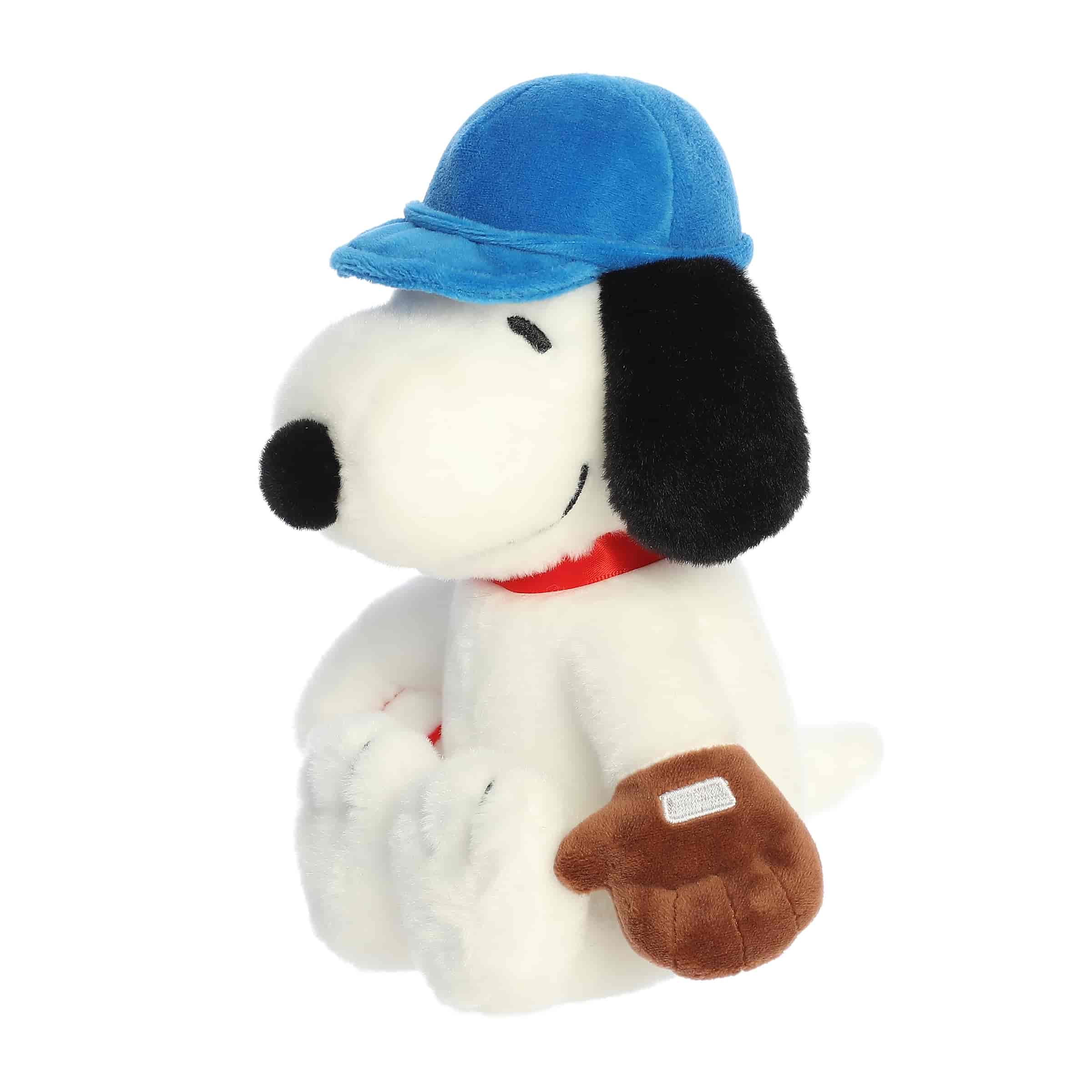 A Snoopy plush wearing a blue baseball cap and holding a brown glove from the Peanuts collection