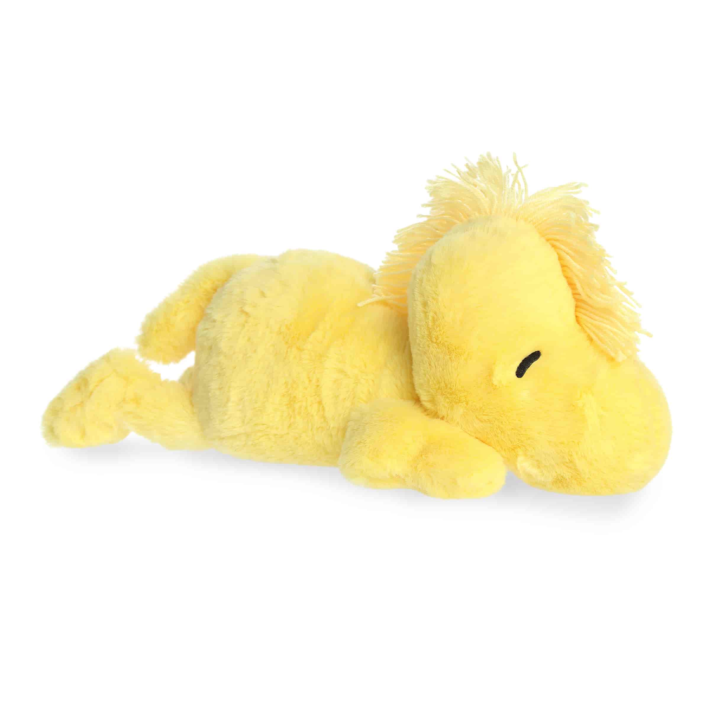 A large yellow Woodstock plush lying down with a soft body and sweet smile from the Peanuts collection