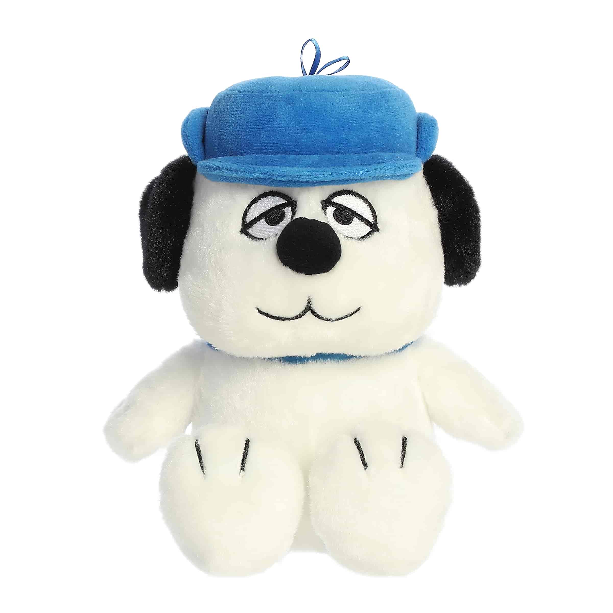A Snoopy plush with soft white fur wearing a blue cap and smiling face from the Peanuts collection
