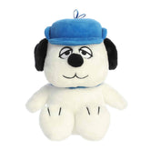 A Snoopy plush with soft white fur wearing a blue cap and smiling face from the Peanuts collection