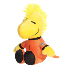 A yellow Woodstock plush wearing an orange astronaut suit from the Peanuts collection by Aurora.