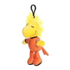 A yellow Woodstock keychain plush wearing an orange astronaut suit from the Peanuts collection by Aurora.