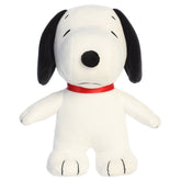 A Snoopy plush toy from Aurora with his signature look and beans in his feet.