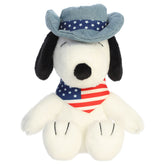 A Snoopy plush toy from Aurora with a blue hat and an American flag bandana.