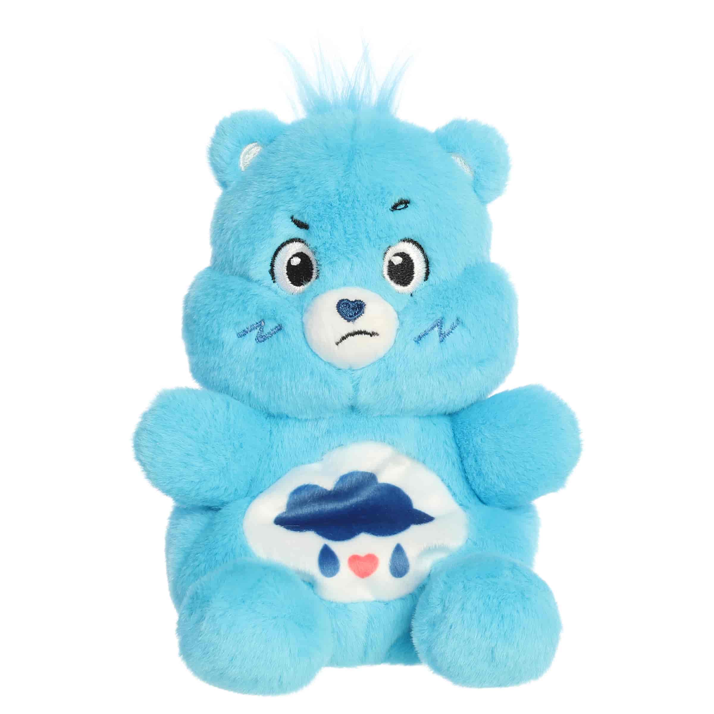 Grumpy Bear Palm Pals plush with soft blue fur, tiny hair tuft, grumpy face, and rain cloud belly badge