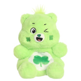 Good Luck Bear Palm Pals plush with soft green fur, winking face, round ears, and shamrock belly badge