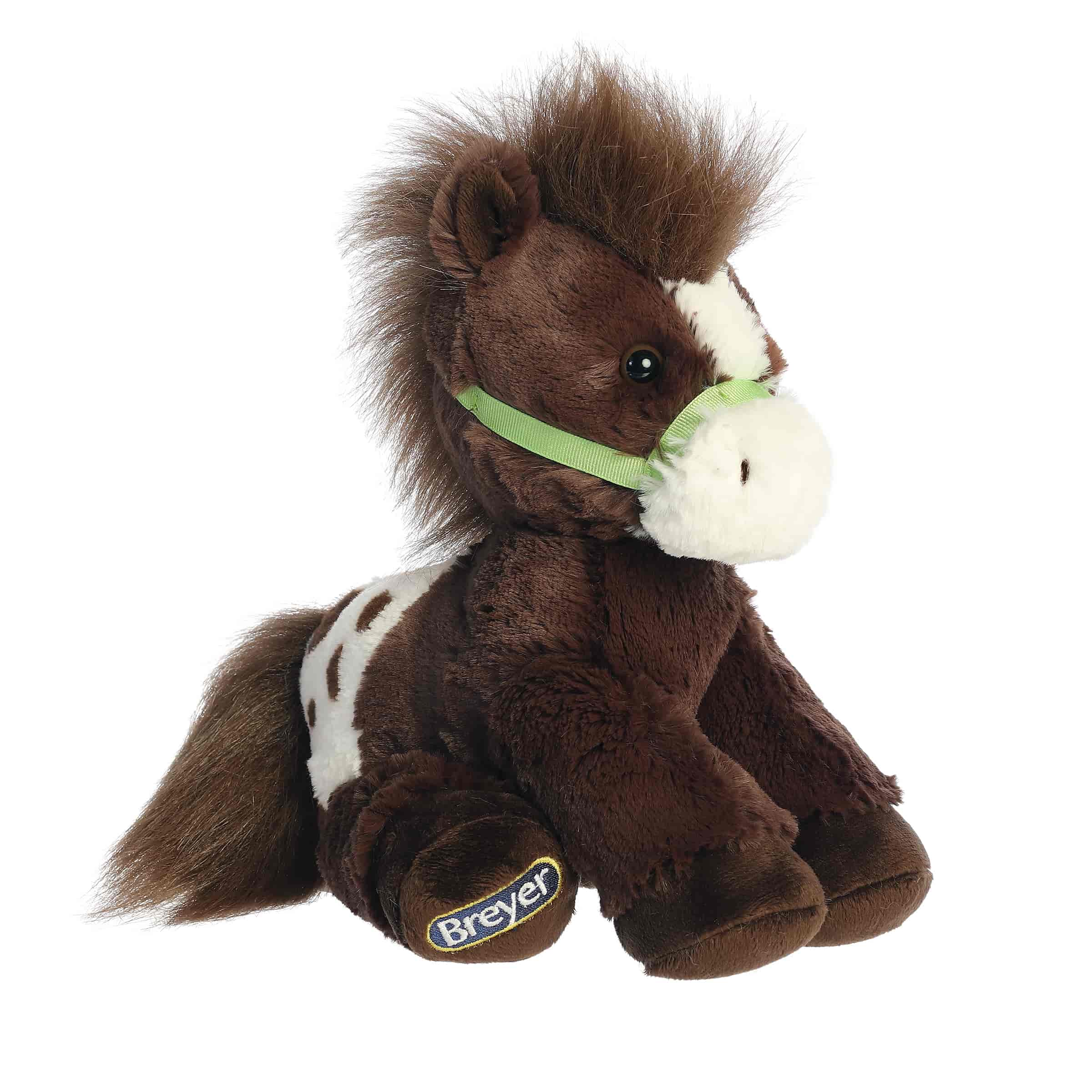 A brown Appaloosa plush horse with a white-spotted blanket and green halter from Bridle Buddies by Breyer.
