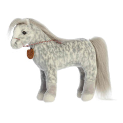 A dapple-gray Trakehner plush horse with a flowing mane, tail, and stitched halter from Showstoppers by Breyer