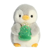 Pompom With Christmas Tree plush penguin from Aurora, holding a decorated tree, perfect for holiday decor and cuddles.