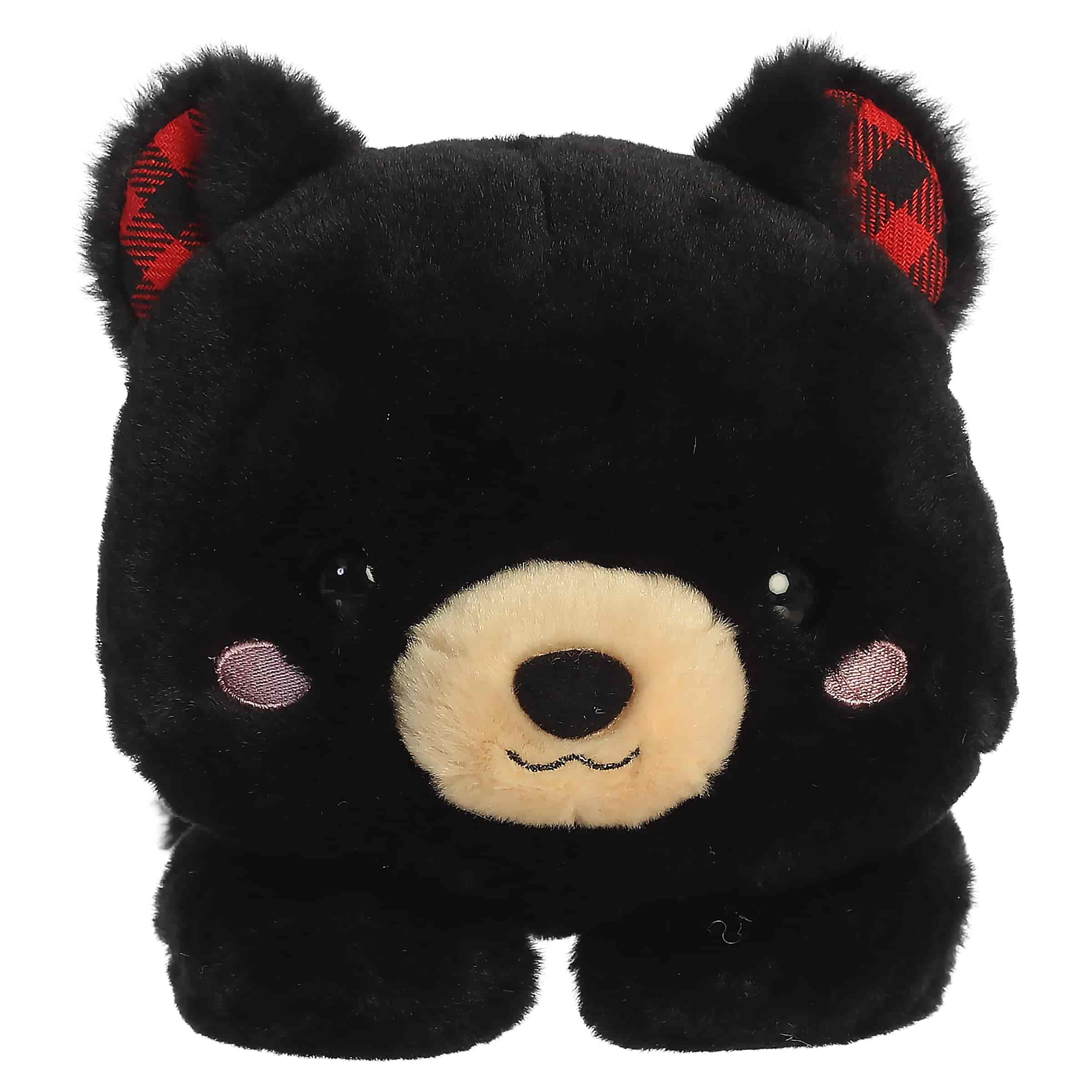 Black bear plush with plaid ear details and a relaxed belly-down pose