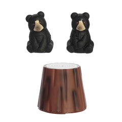 A Grow Black Bear toy by Aurora Toys with a bear hidden inside a faux tree trunk that grows in water