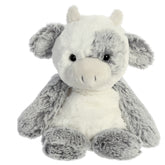 A plush cow toy from Aurora with grey and white fur and a paddle-legged design