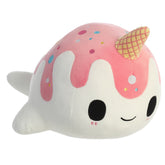 A pink and white Nomwhal plush toy from Tasty Peach Aurora with a waffle cone horn, sprinkles, and soft narwhal shape