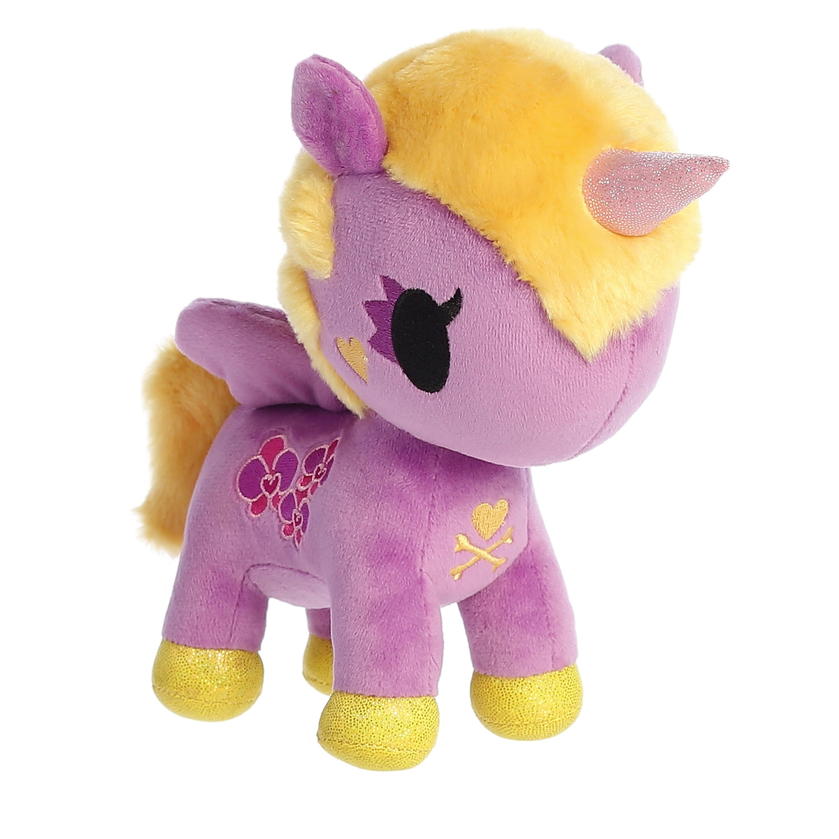A unicorn with a purple horn, yellow fur and hooves, and a delicately embroidered orchid symbol on its side.