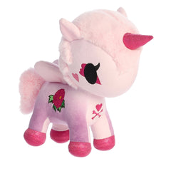 A unicorn with a pink body and hot-pink hooves and horn while sporting an embroidered peony on its side.