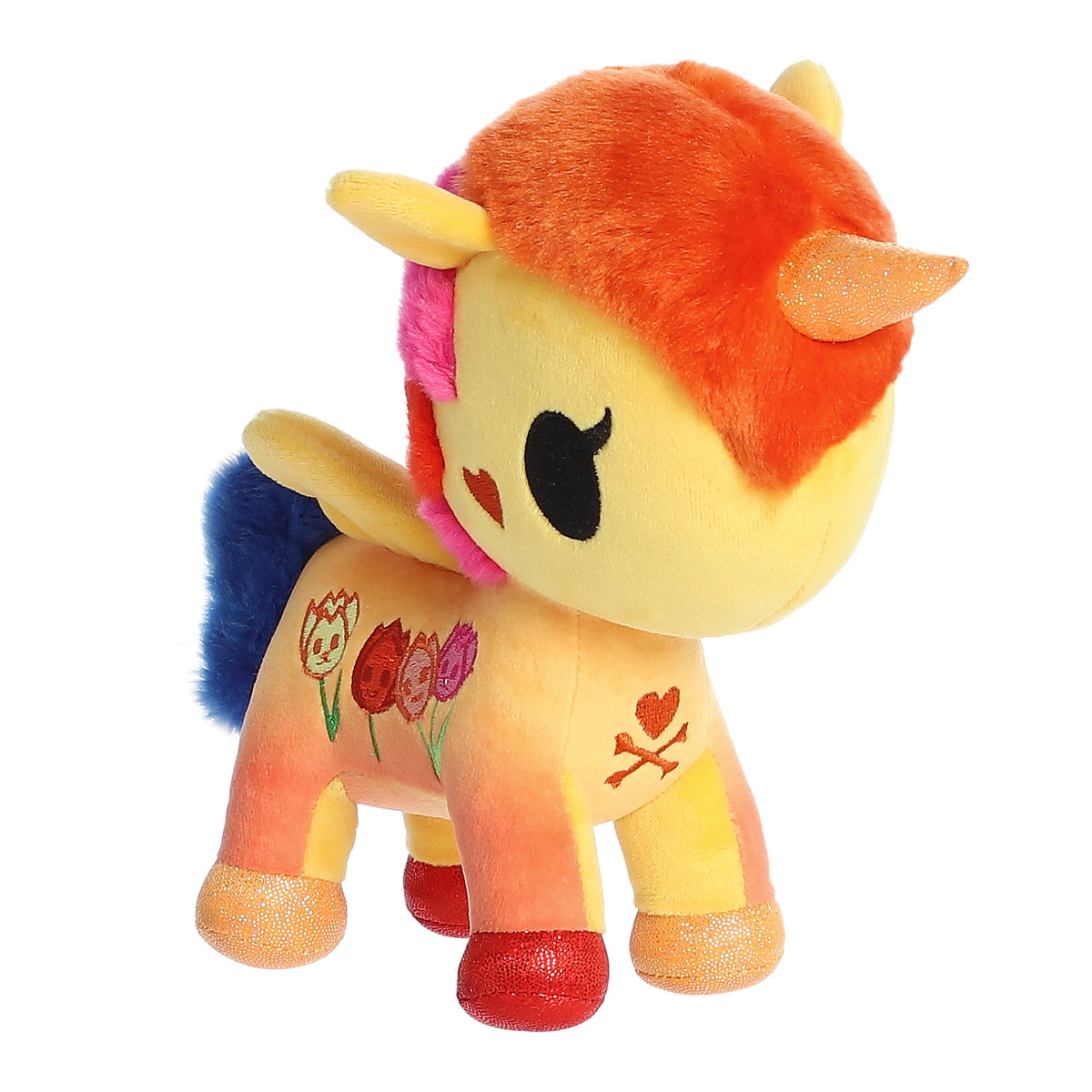 A blazing yellow and orange unicorn plush with four detailed embroidered tulips on its side.