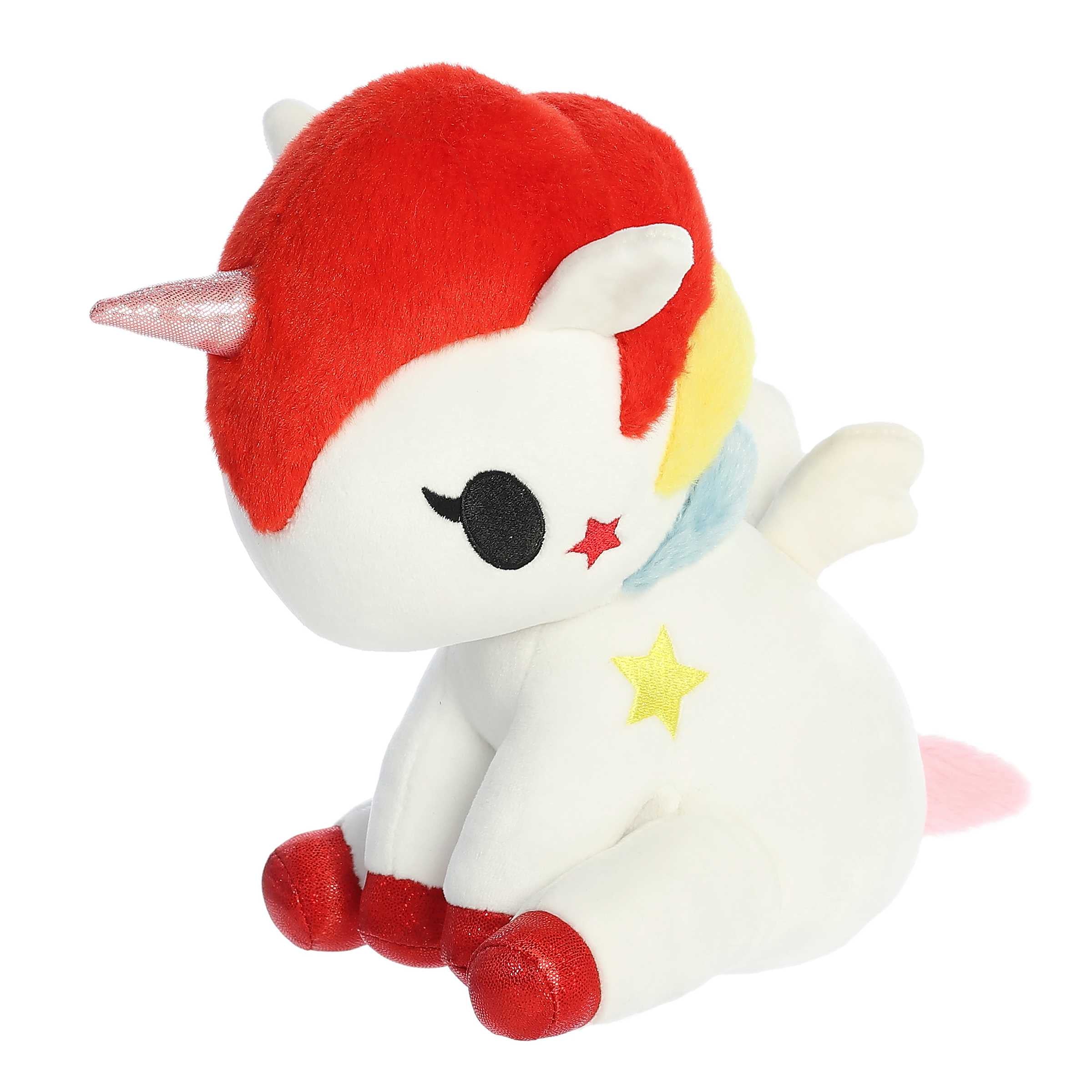 Cute colorful unicorn plush in a sitting position with white body and colorful fur, sparkly hooves and detailed embroidery.