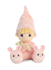 A plush doll from Precious Moments in a pink polka-dot nightgown with blonde yarn hair and bunny slippers.