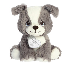 A sitting-down gray and white terrier dog plush with tear-drop eyes and a precious moments inspirational tag around its neck.