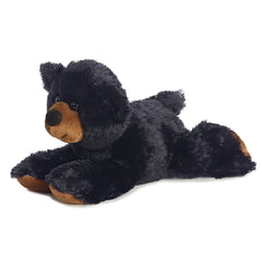 A black bear plush toy from Mini Flopsie by Aurora with a brown snout and soft paws.