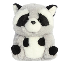 Raccoon plush, with black-framed eyes and white accents on a gray coat, perched playfully, with arms on the tum and legs up.